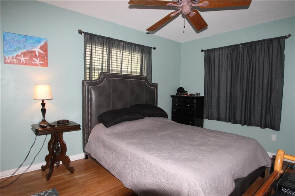 1153 Northwest Spruce Ridge Drive Stuart, FL 34994 - Photo 11 of 22 a bedroom with a bed and a chandelier