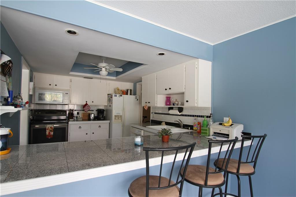 1153 Northwest Spruce Ridge Drive Stuart, FL 34994 - Photo 16 of 22 a kitchen with sink cabinets and stainless steel appliances