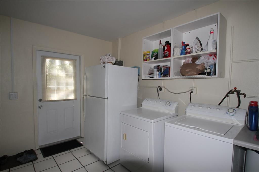 1153 Northwest Spruce Ridge Drive Stuart, FL 34994 - Photo 17 of 22 a view of storage and utility room with washer and dryer