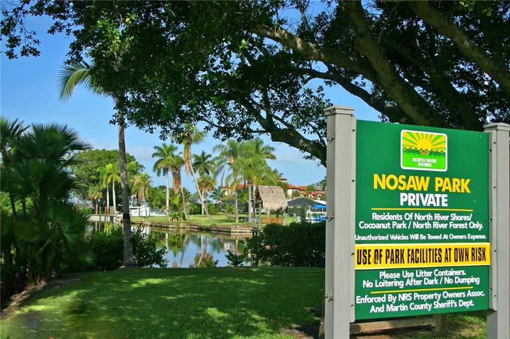 1153 Northwest Spruce Ridge Drive Stuart, FL 34994 - Photo 21 of 22 a sign of a house with a garden
