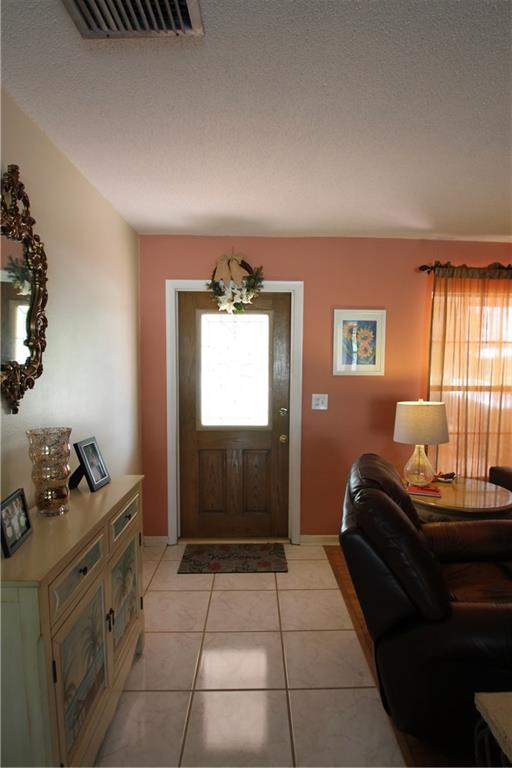 1153 Northwest Spruce Ridge Drive Stuart, FL 34994 - Photo 3 of 22 a room with furniture a window and dresser
