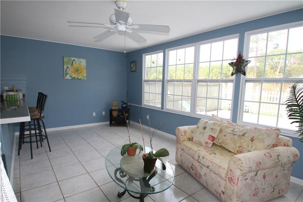 1153 Northwest Spruce Ridge Drive Stuart, FL 34994 - Photo 6 of 22 a living room with furniture and a large window