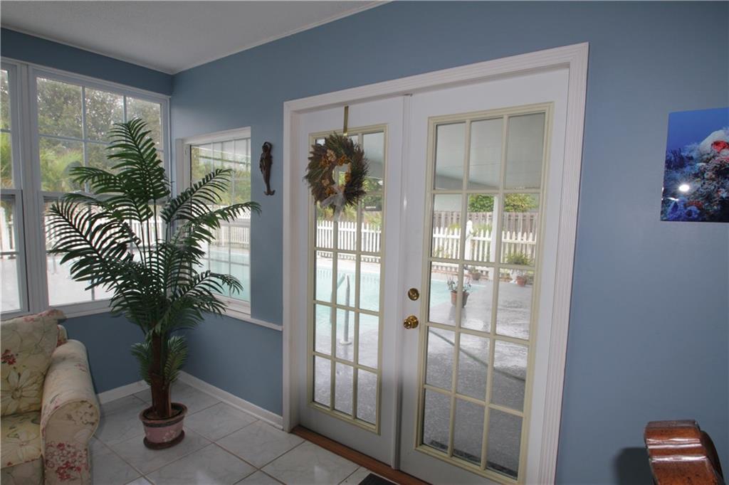 1153 Northwest Spruce Ridge Drive Stuart, FL 34994 - Photo 7 of 22 a view of entryway with wooden floor and door