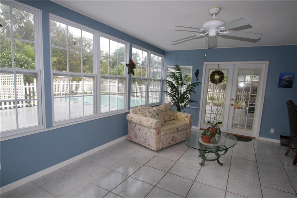 1153 Northwest Spruce Ridge Drive Stuart, FL 34994 - Photo 8 of 22 a living room with furniture and a large window