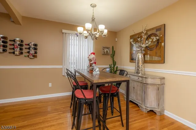 a view of a dining room with furniture wooden floor and a chandelier