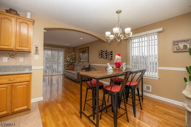 a view of a dining room with furniture and a chandelier