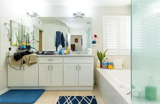 a bathroom with a sink a mirror and a bathtub