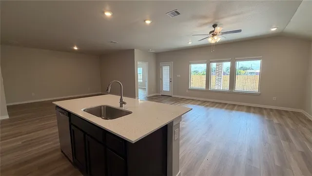 a kitchen with sink and chandelier