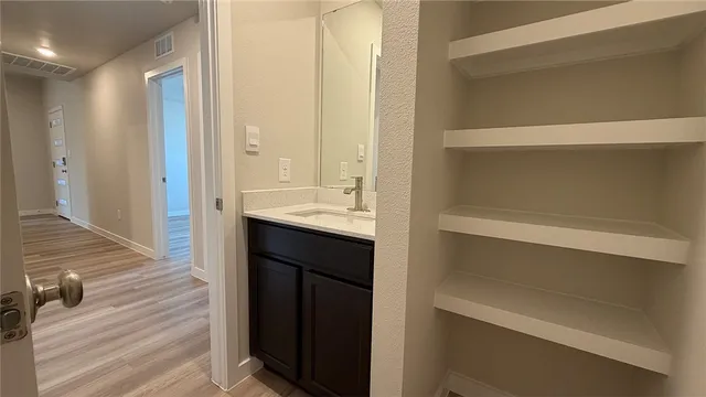 a en suite bathroom with a sink and a mirror