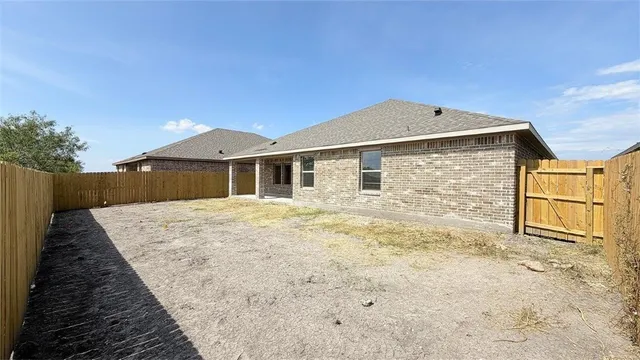 a view of an house with wooden fence