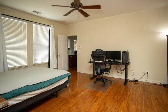 a bedroom with a bed and a desk