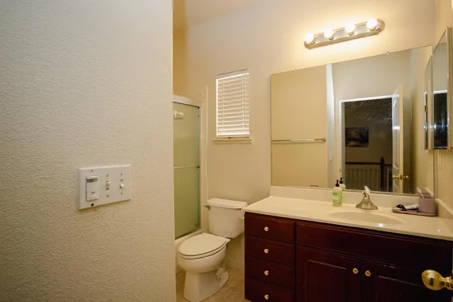 a bathroom with a toilet a sink a mirror and a bathtub