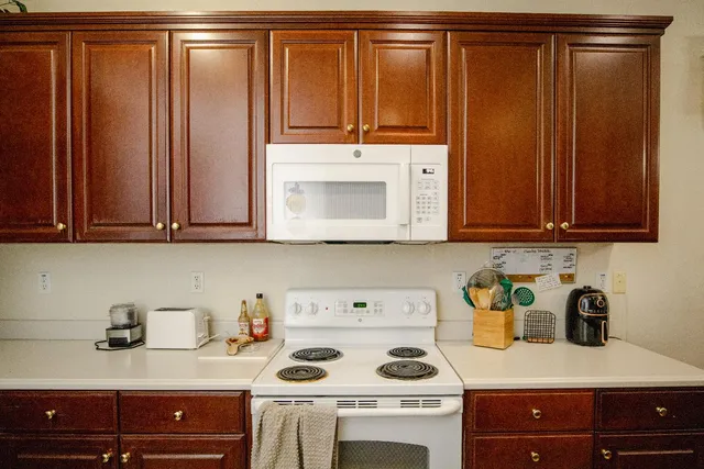 a kitchen with a cabinets and white appliances
