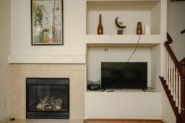 a living room with a fireplace and a flat screen tv