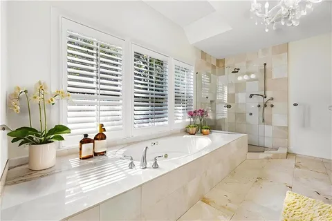 a bath room with a large tub and sink