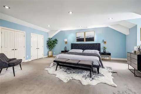 a bedroom with a bed and a potted plant