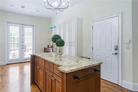 a utility room with kitchen island a wooden floor and living room