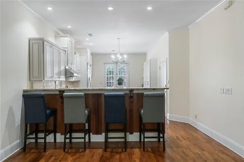 a kitchen with granite countertop a window and chairs