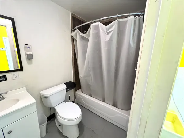 a white toilet sitting next to a bathroom sink