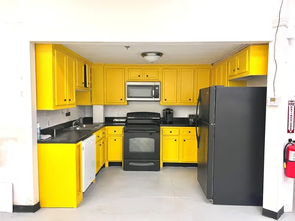 a kitchen with a refrigerator and a stove