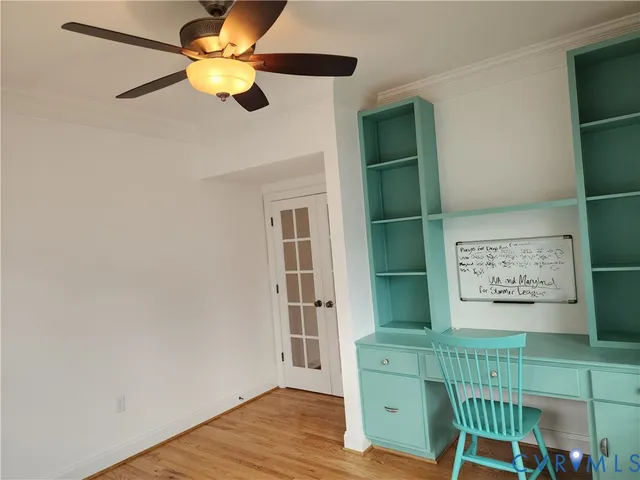 an empty room with a window and wooden floor
