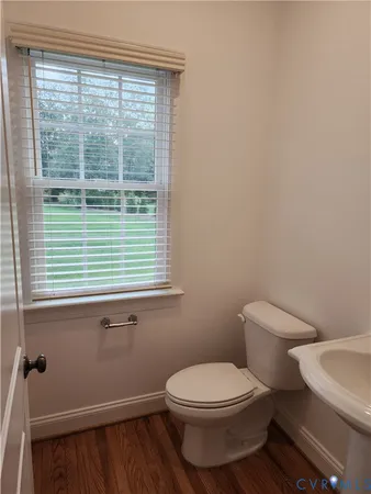 a white toilet sitting next to a window