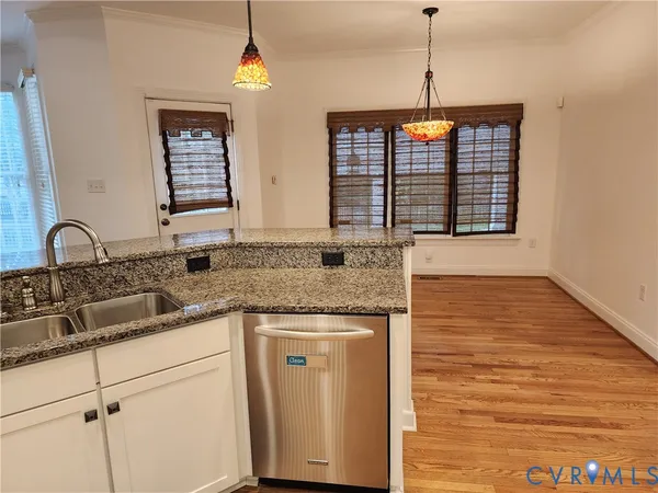 a kitchen with granite countertop a sink and a stove