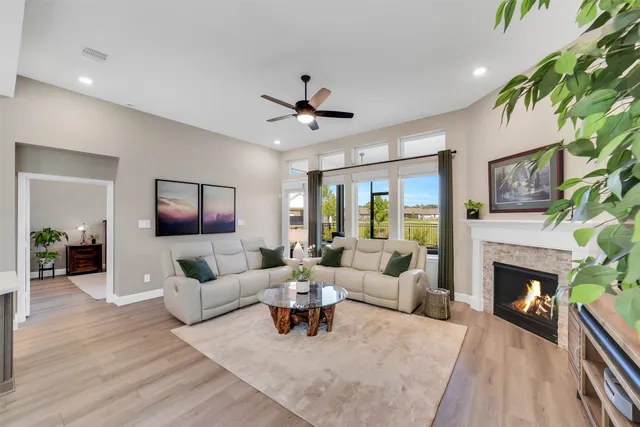 a living room with furniture a fireplace and a flat screen tv
