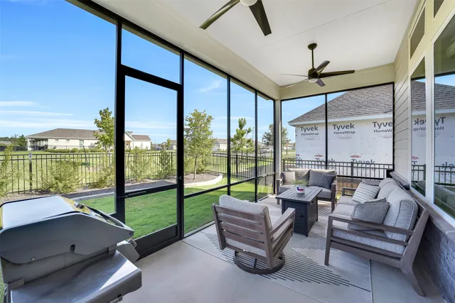 a living room with furniture and a floor to ceiling window