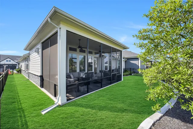 a view of an house with backyard space and garden