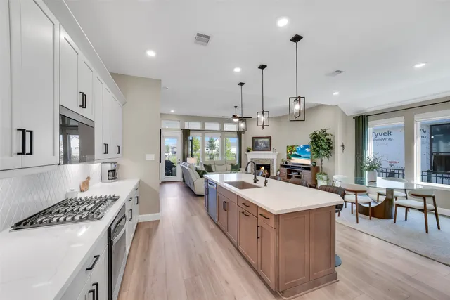 a large kitchen with a table and chairs