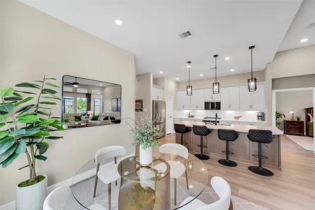 a large kitchen with a table and chairs