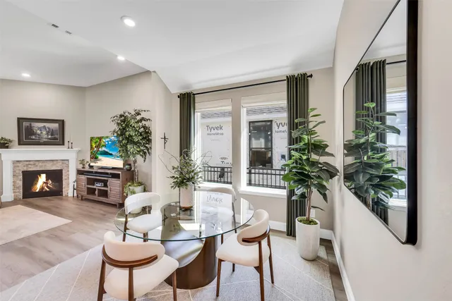 a living room with furniture a potted plant and a fireplace