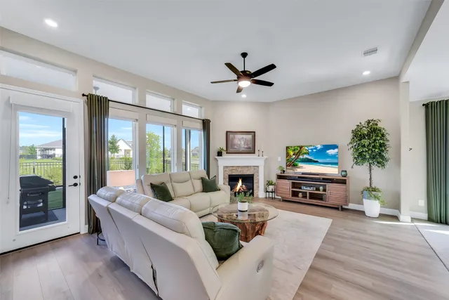 a living room with furniture a fireplace and a potted plant