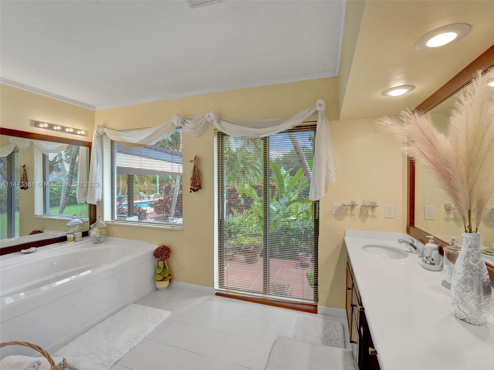 Flamingo Groves Davie, FL 33330 - Photo 30 of 43 a spacious bathroom with a tub and sink