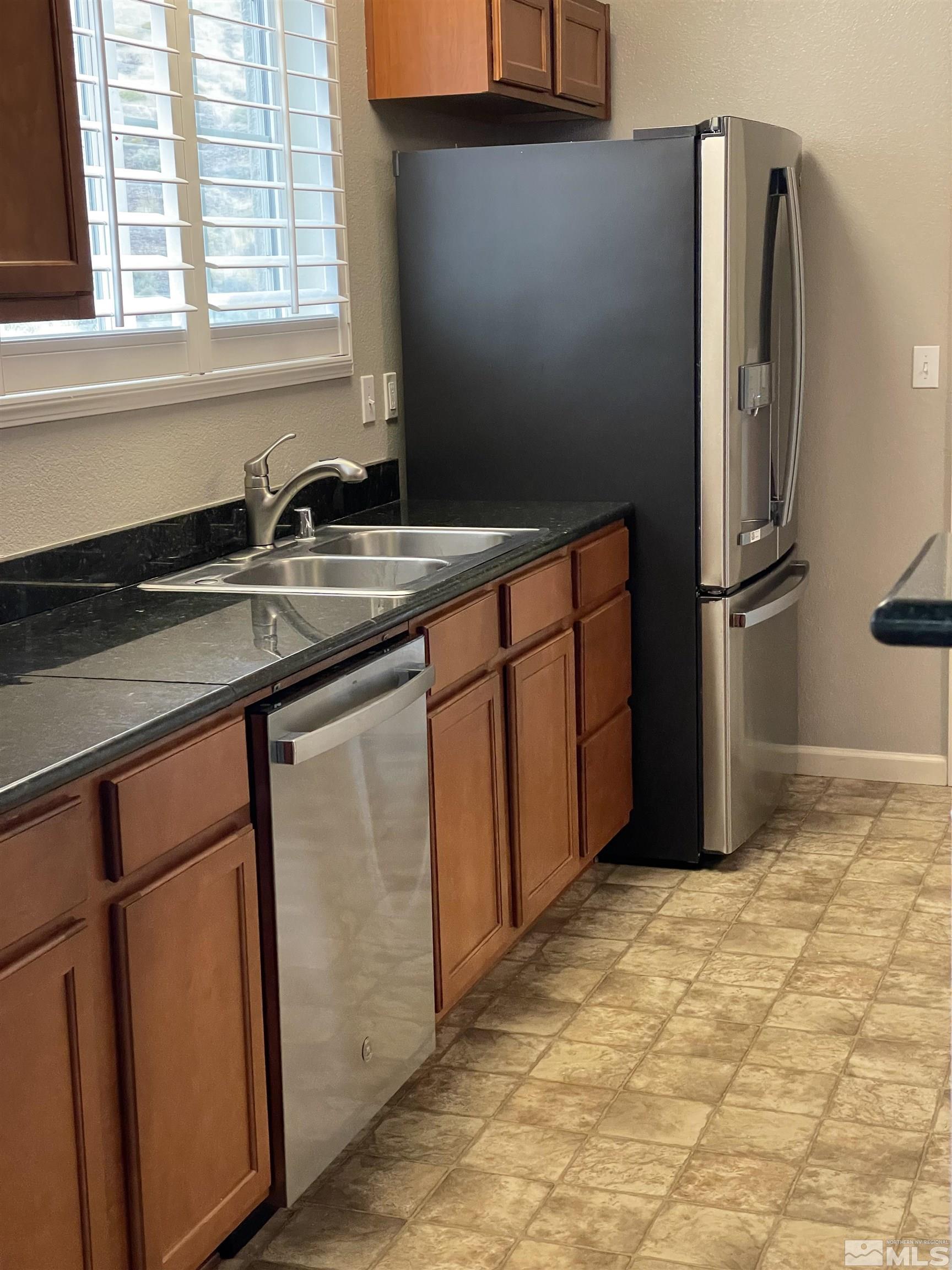 9050 Double R Boulevard, Unit 1024 Reno, NV 89521 - Photo 8 of 32 a kitchen with stainless steel appliances granite countertop a refrigerator and a sink