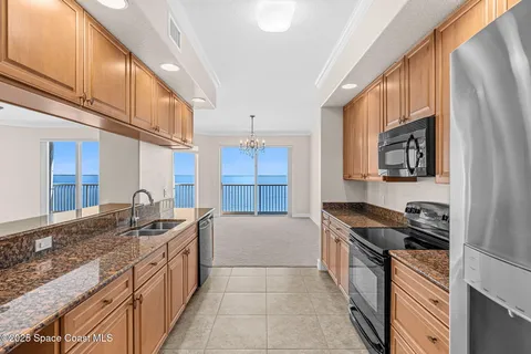 a kitchen with stainless steel appliances granite countertop a refrigerator stove and microwave