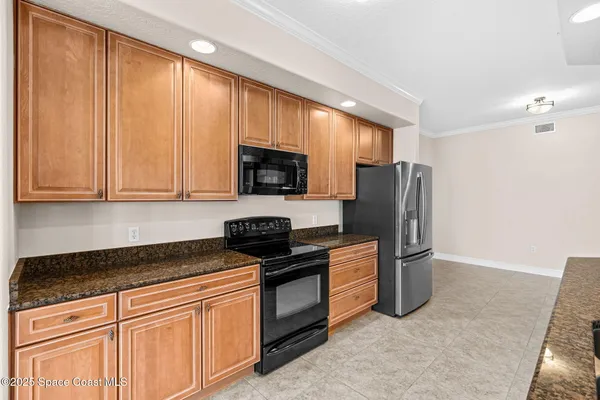 a view of kitchen with wooden floor and refrigerator