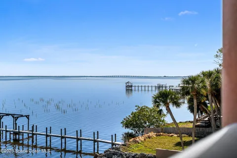 a view of a hallway with wooden shelves