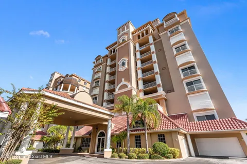 a front view of a residential apartment building with a yard