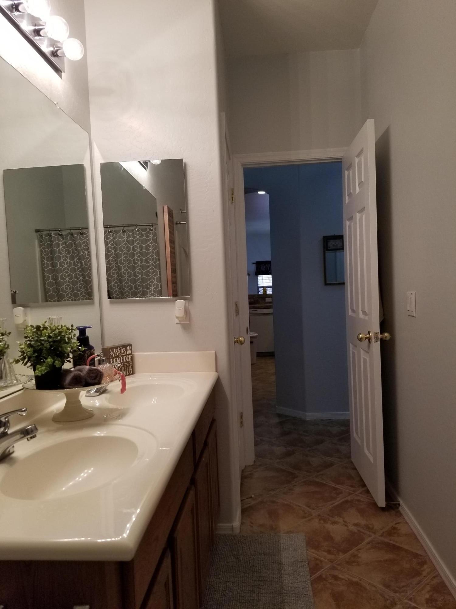 15801 West Redfield Road Surprise, AZ 85379 - Photo 21 of 26 a bathroom with a sink and a mirror