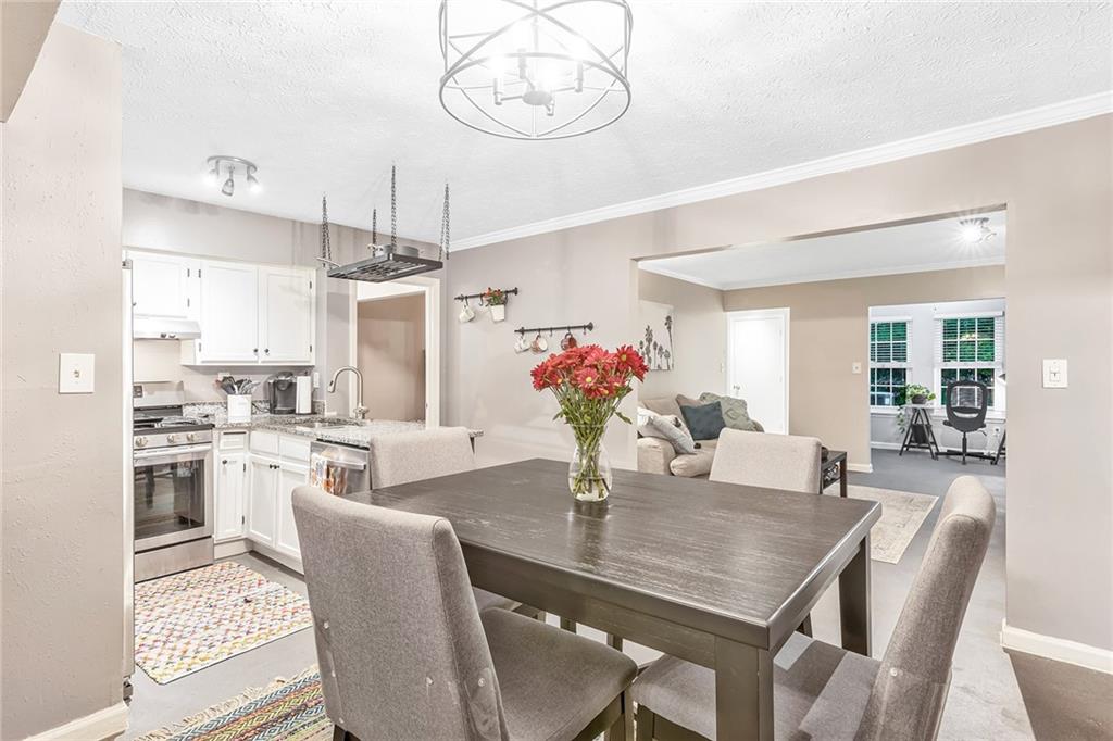 2021 Brian Way Decatur, GA 30033 - Photo 1 of 1 a dining room with wooden floor a chandelier a wooden table and chairs