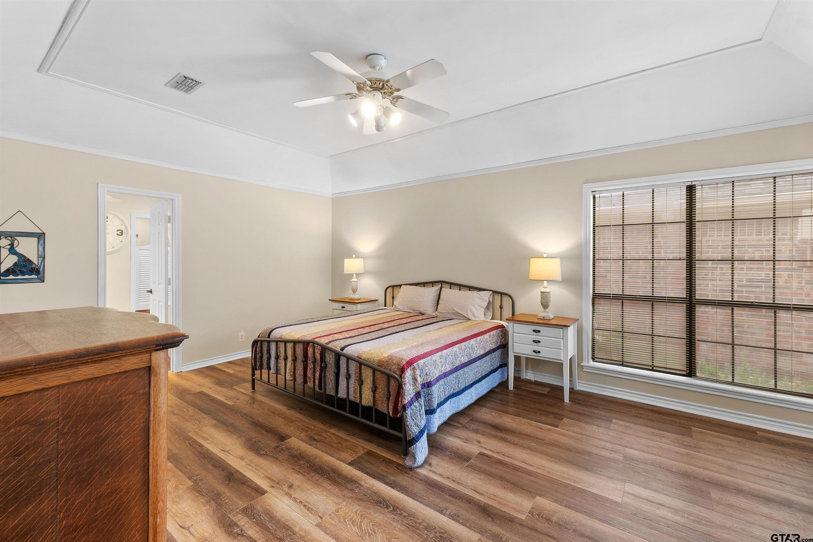 509 Buckingham Place Tyler, TX 75701 - Photo 18 of 35 a bedroom with a bed and a large window