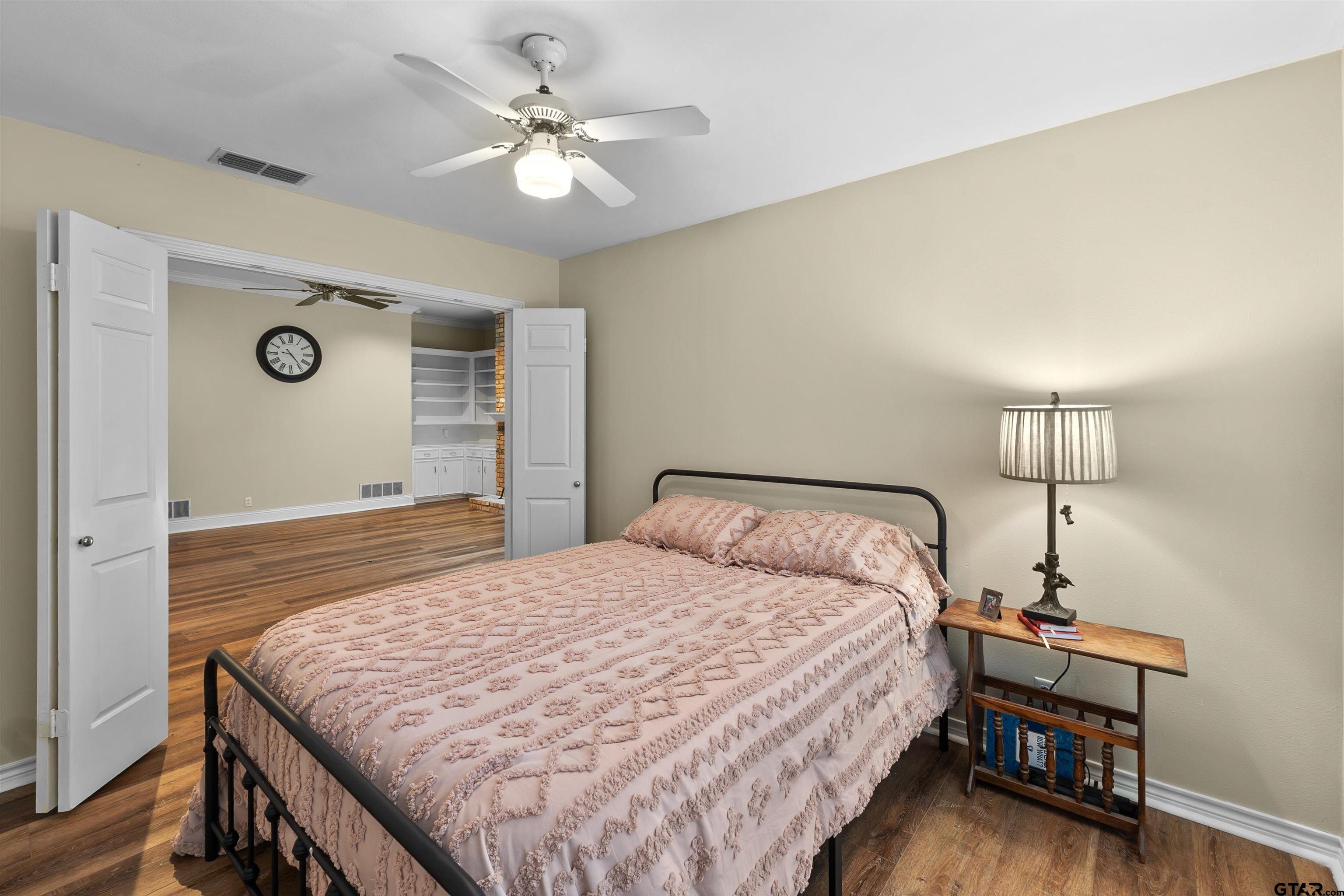 509 Buckingham Place Tyler, TX 75701 - Photo 24 of 35 a bedroom with a bed and a chandelier