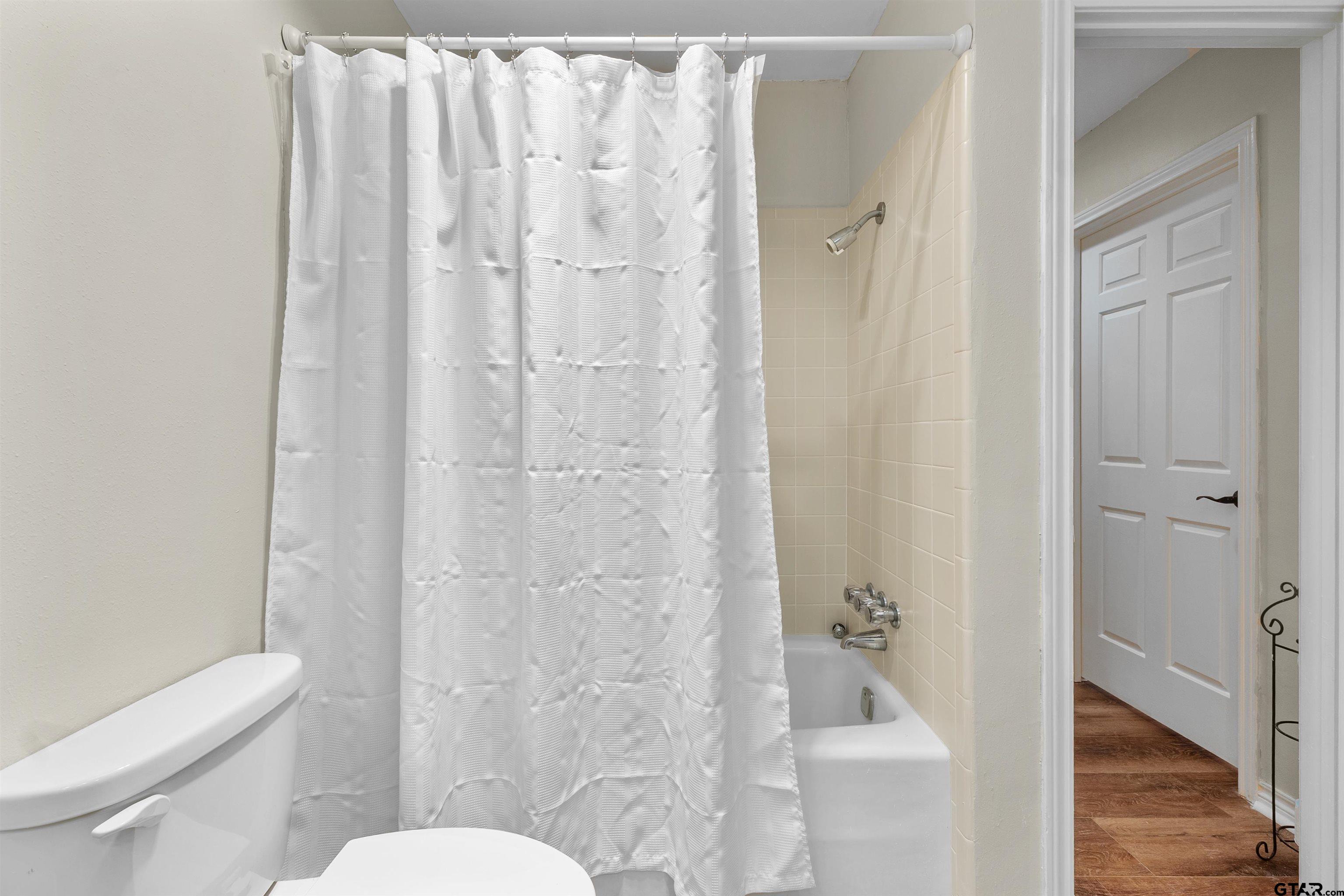 509 Buckingham Place Tyler, TX 75701 - Photo 26 of 35 a white toilet sitting next to a bathroom sink