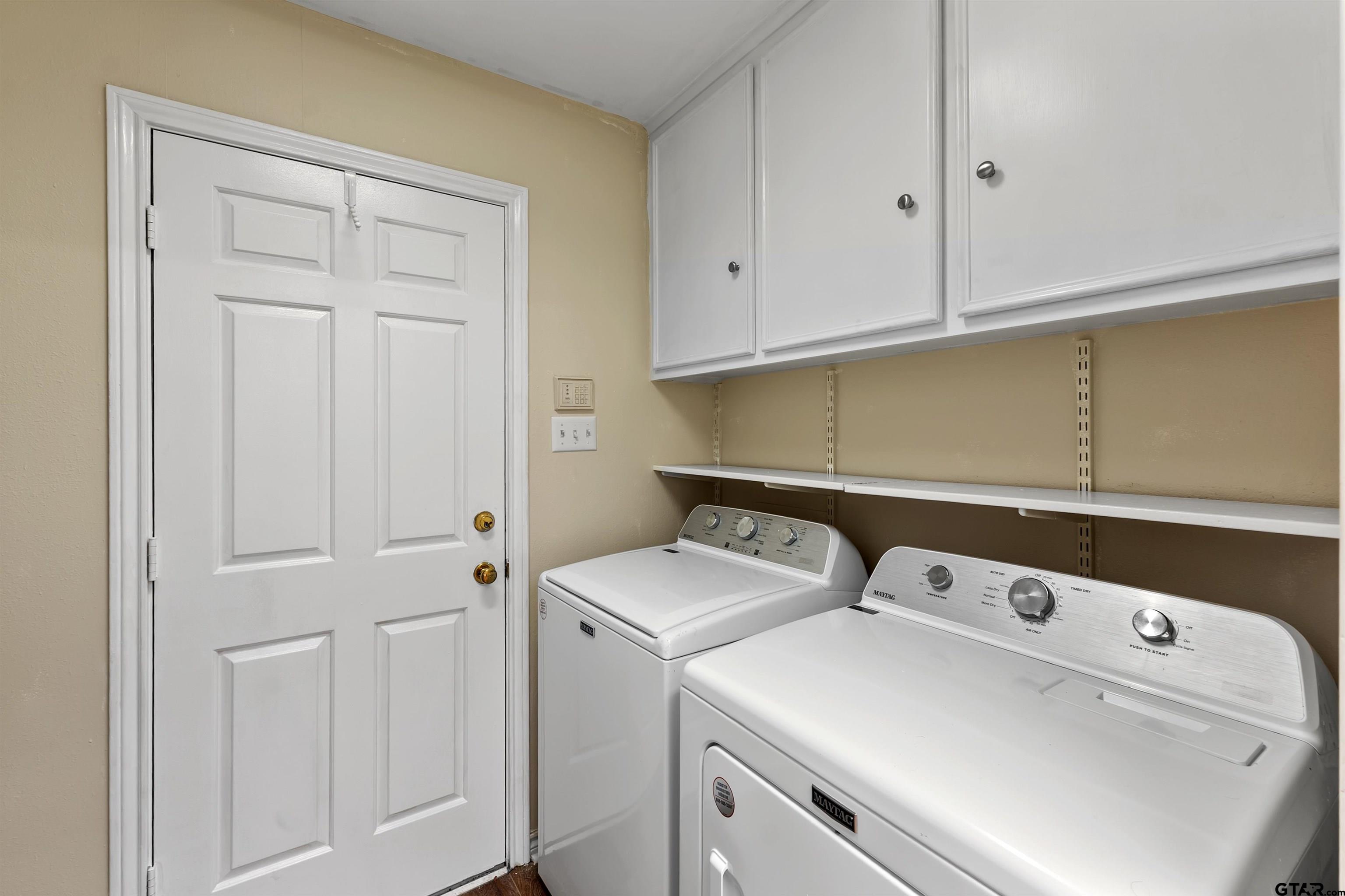509 Buckingham Place Tyler, TX 75701 - Photo 29 of 35 a utility room with dryer and washer