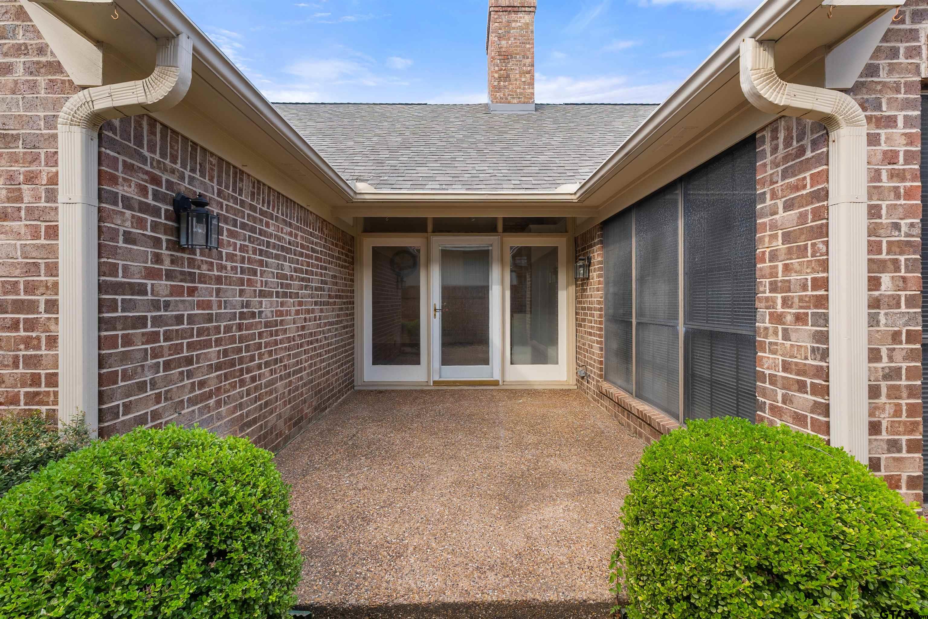 509 Buckingham Place Tyler, TX 75701 - Photo 31 of 35 a front view of a house with a garden