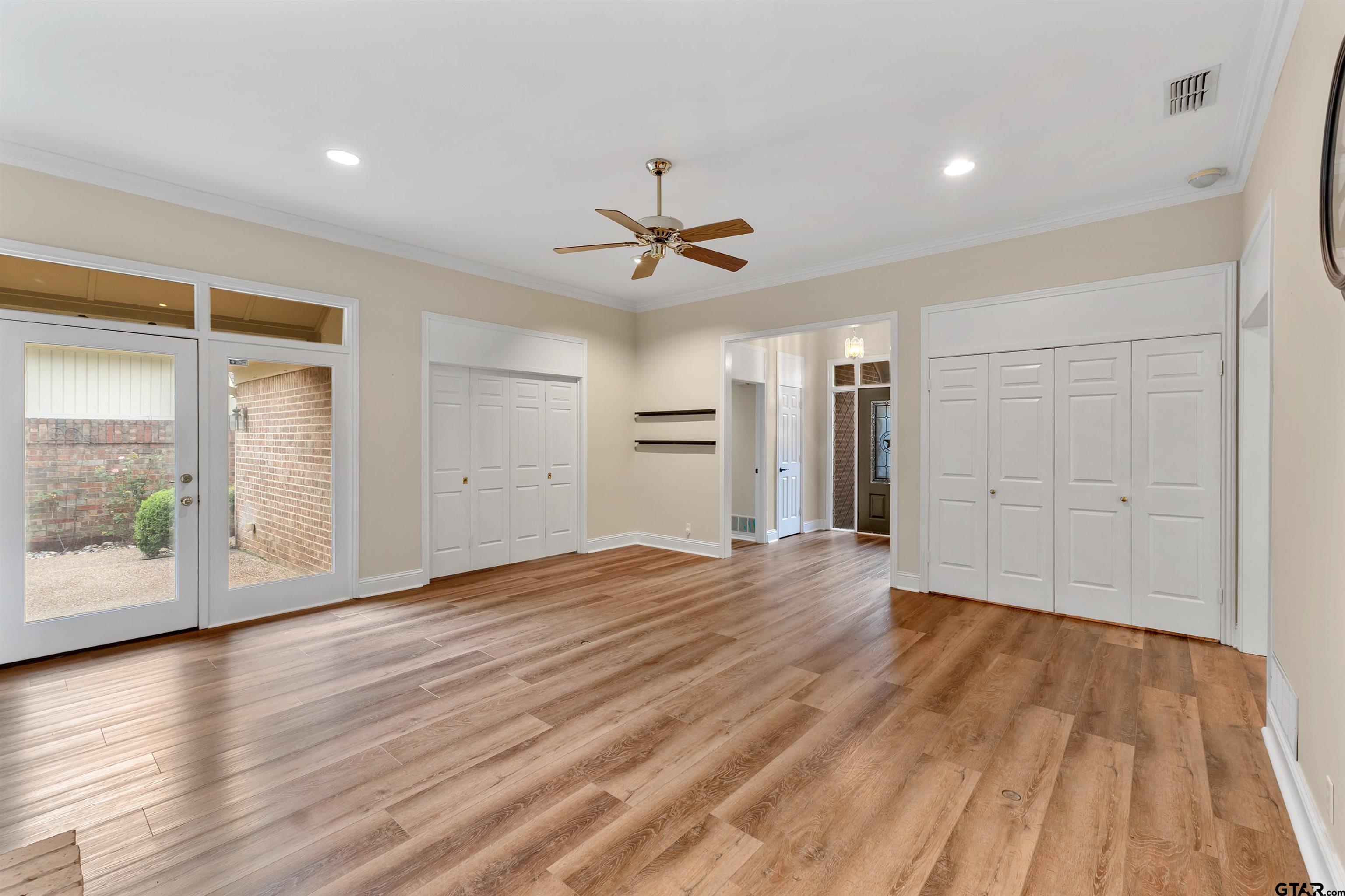 509 Buckingham Place Tyler, TX 75701 - Photo 8 of 35 wooden floor in an empty room with a window