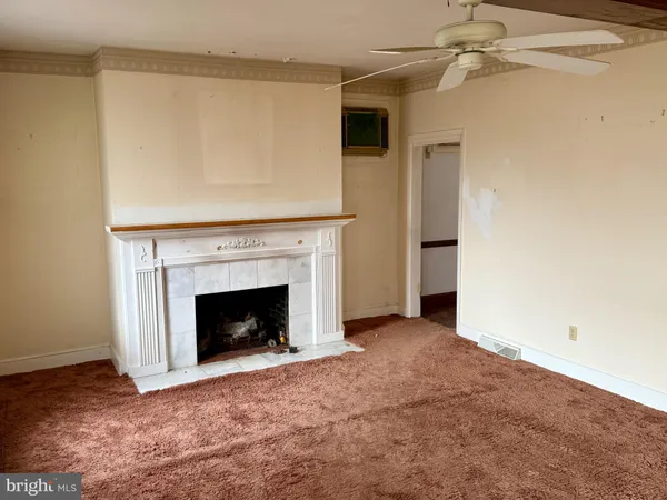 a view of an empty room with a fireplace