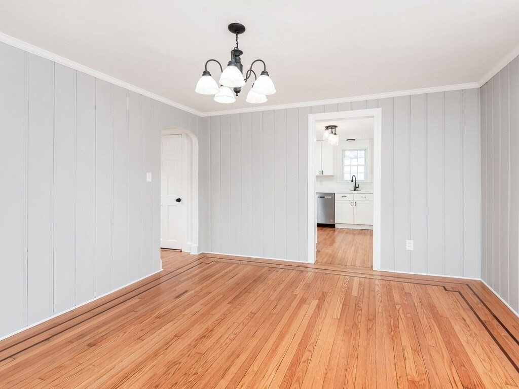 63 Upland Street Worcester, MA 01607 - Photo 11 of 36 a view of a room with wooden floor and a ceiling fan